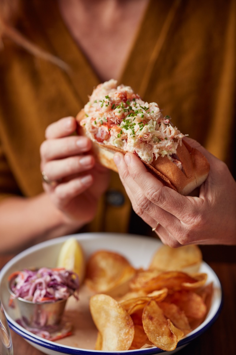 Woman holding a lobster roll
